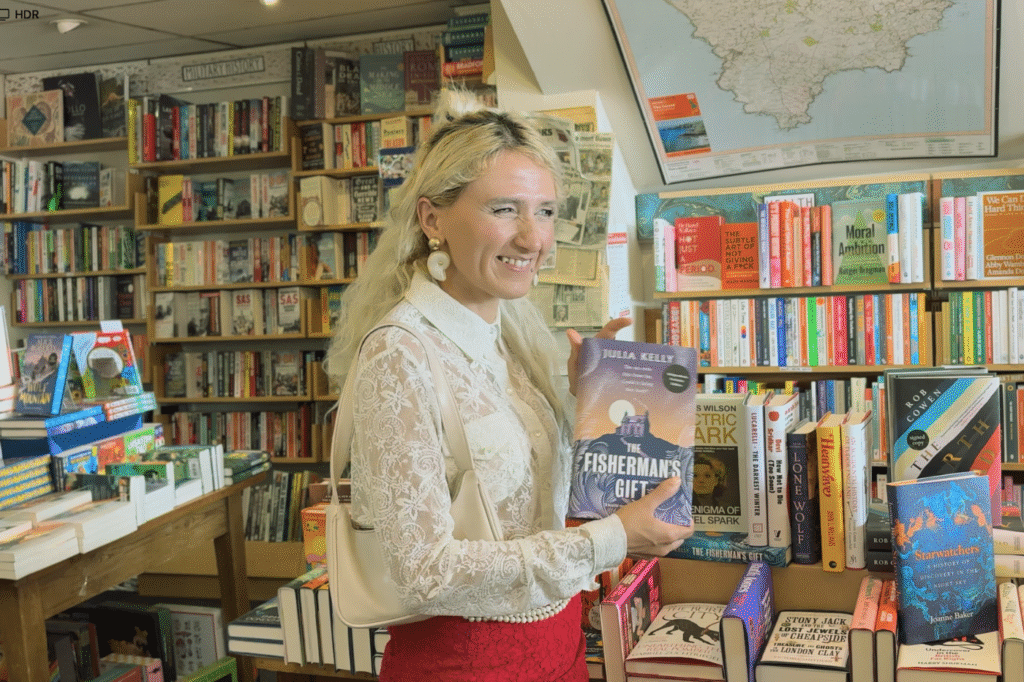 Woman holding a book in bookstore.
